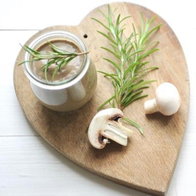 Cream of mushroom soup with rosemary served in a jar.