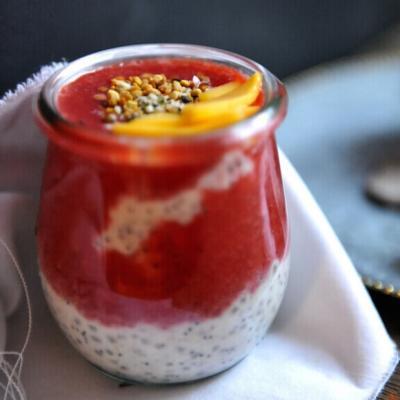 Chia seeds recipe for chia porridge layered with wild strawberry sauce in a jar.