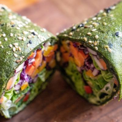 Raw food wraps with vegetable salad filling and guacamole dip