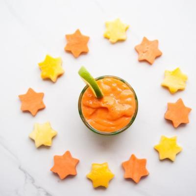 Vegetable smoothie recipe with sweet potato. Arranged in a glass with vegetable stars and a wedge of lime.
