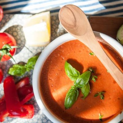 Vegetable smoothie made with tomatoes, peppers, celery and herbs in a bowl for spooning.