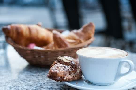 Acidic foods like croissant and coffee with milk