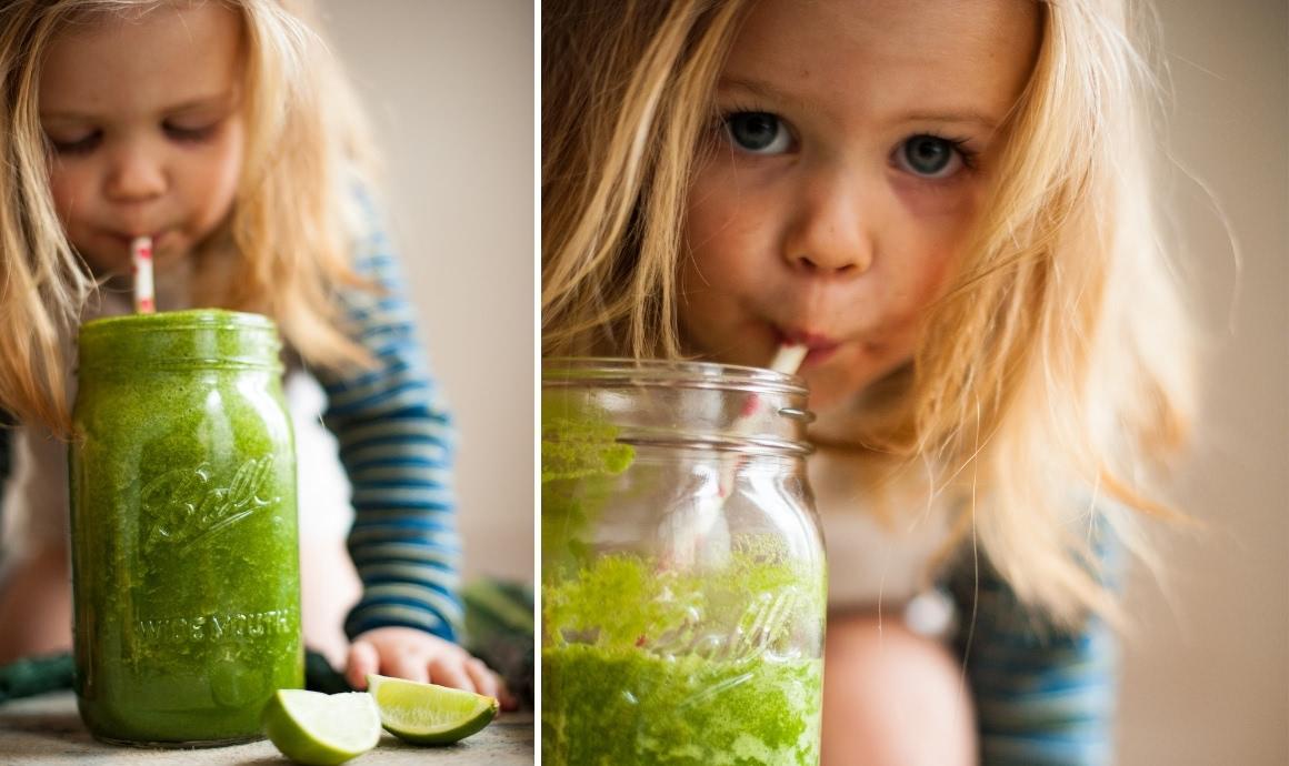 Little girl drinking green smoothies