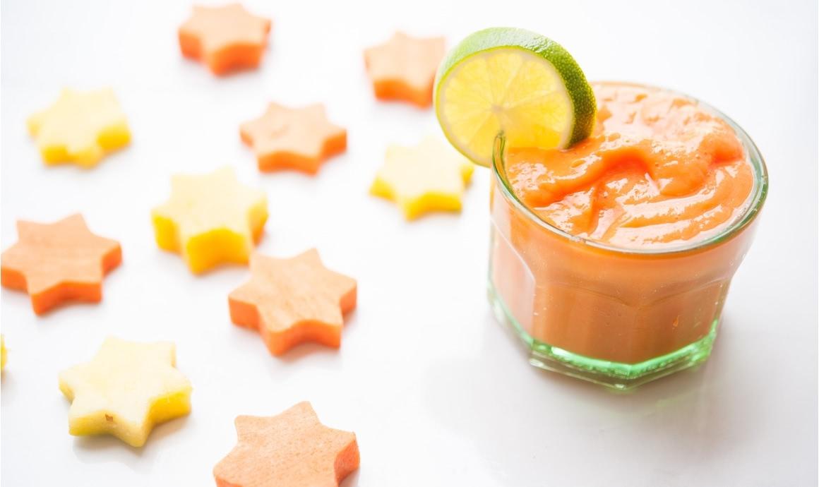 Vegetable smoothie of sweet potato, mango and lime in a glass.