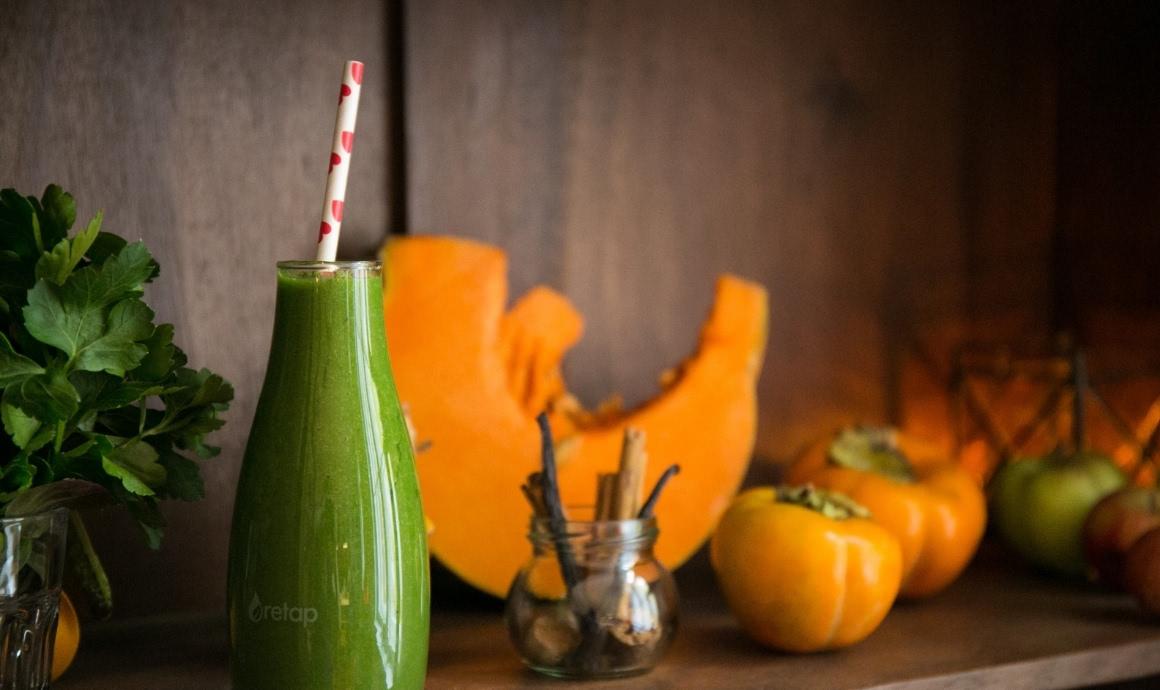Filled smoothie bottles with a column nutmeg pumpkin and vanilla and cinnamon sticks.
